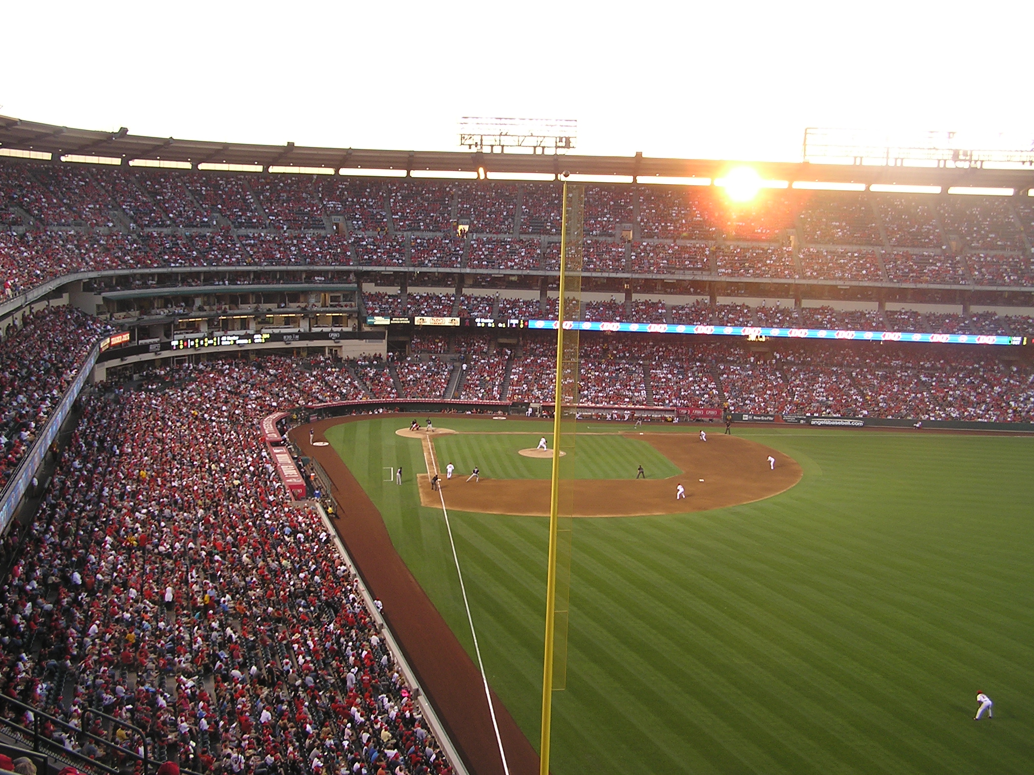 The Sun sets through the opening at Angel Stadium